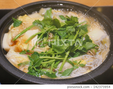Sendai's famous seri nabe (Japanese parsley hot pot) is made by simmering plenty of seri in a pot. Sendai's famous seri nabe (Japanese parsley hot pot) is made by simmering plenty of seri in a pot. 142373954