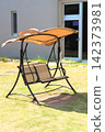 Covered swing benches and lawn scenery placed in gardens and outdoor rest areas. 142373981