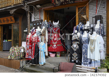 Shop with national Chinese women's dresses of the Miao tribe in Fenghuang, China Shop with national Chinese women's dresses of the Miao tribe in Fenghuang, China 142374302