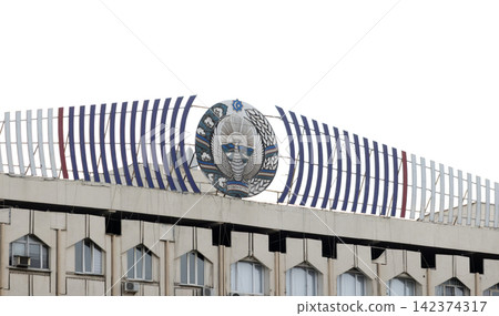 National emblem crowns a government building's distinctive striped roof and pointed-arch windows. National emblem crowns a government building's distinctive striped roof and pointed-arch windows. 142374317