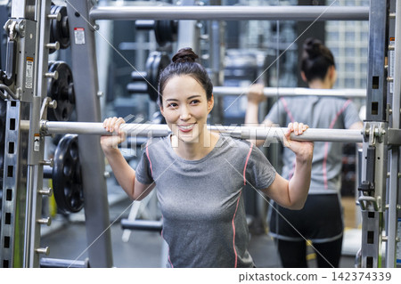 Young woman training in a sports gym Young woman training in a sports gym 142374339