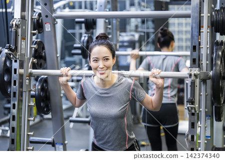 Young woman training in a sports gym Young woman training in a sports gym 142374340