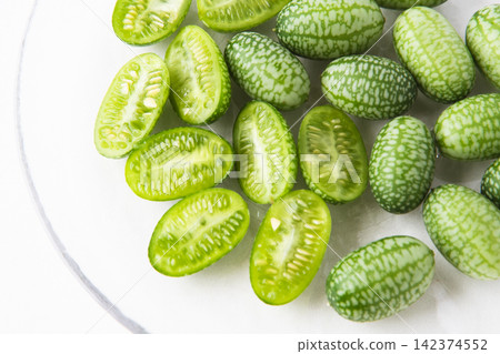 Cross-section of a sliced mini cucumber Cross-section of a sliced mini cucumber 142374552