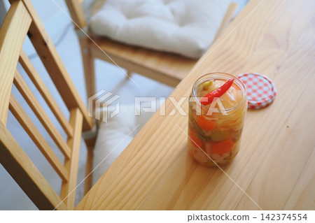 Jar of pickled vegetables on a wooden table Jar of pickled vegetables on a wooden table 142374554
