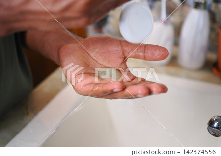 Applying soap on hand in bathroom sink Applying soap on hand in bathroom sink 142374556