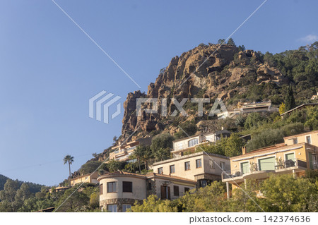 Upscale Mediterranean villas cling to steep volcanic rocks of the Esterel Massif between Cannes and Nice. Upscale Mediterranean villas cling to steep volcanic rocks of the Esterel Massif between Cannes and Nice. 142374636