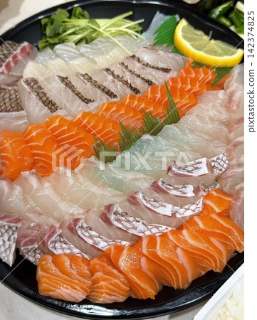 Fresh and delicate sashimi slices, beautifully presented with vibrant colors and perfect cuts. This traditional Japanese delicacy highlights the pure flavors of premium seafood. Fresh and delicate sashimi slices, beautifully presented with vibrant colors and perfect cuts. This traditional Japanese delicacy highlights the pure flavors of premium seafood. 142374825