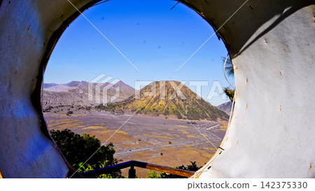 View of Mount Bromo framed by a rattan circle. View of Mount Bromo framed by a rattan circle. 142375330