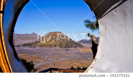 View of Mount Bromo framed by a rattan circle. View of Mount Bromo framed by a rattan circle. 142375331