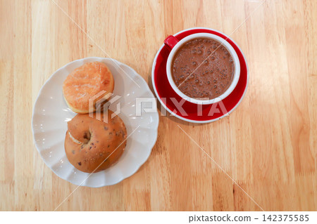 bread, bun or cranberry bread or cranberry bun or cranberry bagel and donut or doughnut with hot cocoa bread, bun or cranberry bread or cranberry bun or cranberry bagel and donut or doughnut with hot cocoa 142375585
