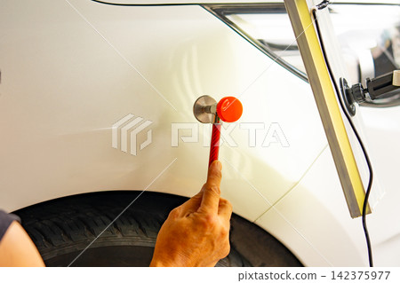 Removing dents on the car. PDR technology. Car body repair without painting. Removing dents on the car. PDR technology. Car body repair without painting. 142375977