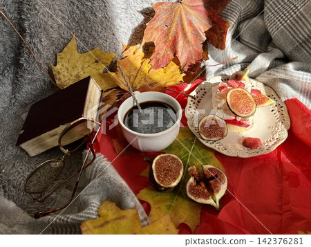 Cozy Autumn Flatlay with Coffee, Meringue Fig Dessert, Book, and Autumn Leaves 142376281