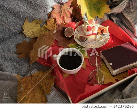 Cozy Autumn Flatlay with Coffee, Meringue Fig Dessert, Book, and Autumn Leaves Cozy Autumn Flatlay with Coffee, Meringue Fig Dessert, Book, and Autumn Leaves 142376286
