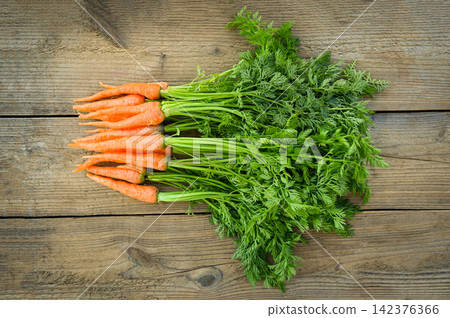 carrot on wooden table background, Fresh and sweet carrots for cooking food fruits and vegetables for health concept, baby carrots bunch and leaf carrot on wooden table background, Fresh and sweet carrots for cooking food fruits and vegetables for health concept, baby carrots bunch and leaf 142376366
