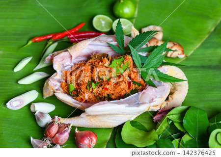 Cannabis food for cooking with fresh chicken cannabis leaf marijuana vegetables herbs and spices ingredients on banana leaf background, raw chicken hemp leaf plant THC CBD herbs - Thai food 142376425