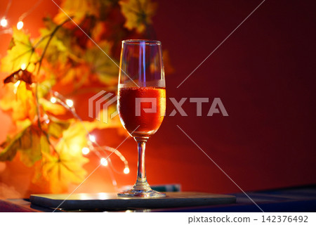 Champagne glass on table against blurred lights background - perspective of crystal clear wine glass for night party on the counter top bar restaurant Champagne glass on table against blurred lights background - perspective of crystal clear wine glass for night party on the counter top bar restaurant 142376492