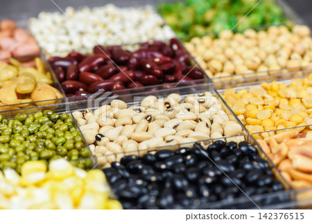 Box of different whole grains beans and legumes seeds lentils and nuts colorful snack background top view - Collage various beans mix peas agriculture of natural healthy food for cooking ingredients 142376515