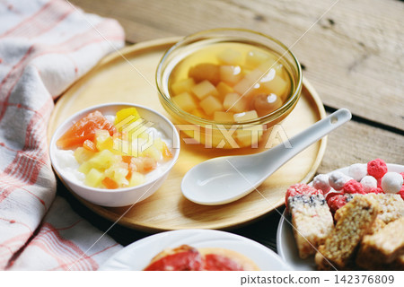 Chinese desserts, milk pudding fruit salad and Mix ginkgo nuts cassava syrup coconut jelly in longan juice on glass bowl, Thai and Chinese longan date soup Asian dessert sweets Chinese desserts, milk pudding fruit salad and Mix ginkgo nuts cassava syrup coconut jelly in longan juice on glass bowl, Thai and Chinese longan date soup Asian dessert sweets 142376809