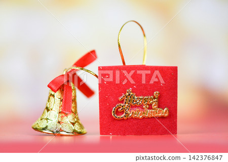 Christmas decoration red ribbon bell with light gold abstract holiday background / christmas festive xmas winter and Happy New Year object 142376847