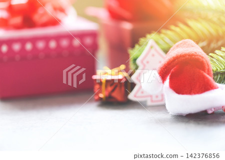 Christmas holiday background with Santa hat and fir branches decoration gift box and festive Happy New Year 142376856