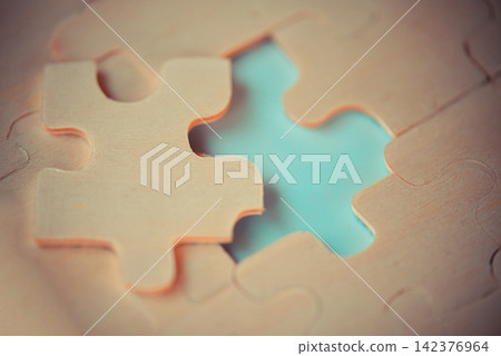jigsaw puzzle / Close up of jigsaw pieces for joining and trying to connect business partnership jigsaw puzzle / Close up of jigsaw pieces for joining and trying to connect business partnership 142376964