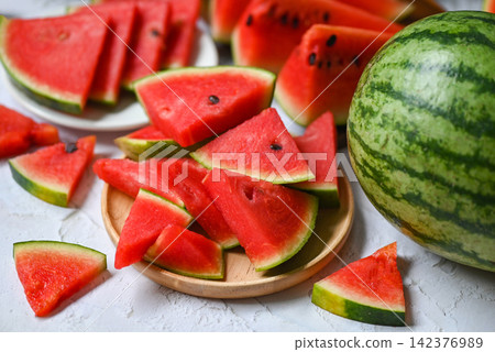Closeup sweet watermelon slices pieces fresh watermelon tropical summer fruit, Watermelon slice on wooden background Closeup sweet watermelon slices pieces fresh watermelon tropical summer fruit, Watermelon slice on wooden background 142376989