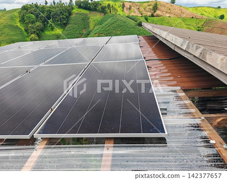 Solar Panels on Rural Rooftop with Green Agricultural Landscape 142377657