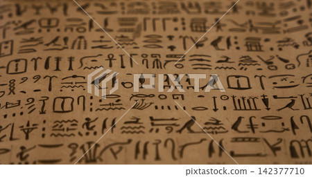 Ancient Egyptian Hieroglyphics on Papyrus Texture Background Ancient Egyptian Hieroglyphics on Papyrus Texture Background 142377710