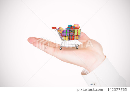 Shopping Cart With Gift Boxes on Open Hand Shopping Cart With Gift Boxes on Open Hand 142377765