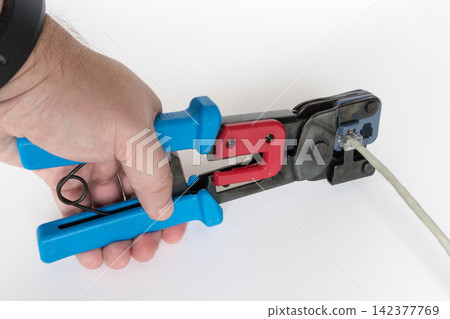 Ethernet Cable Crimping Tool on White Background Ethernet Cable Crimping Tool on White Background 142377769