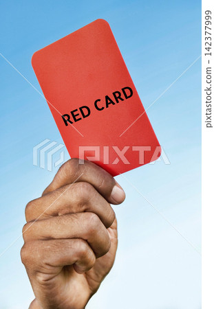 Red Card Held by Hand Against Blue Sky 142377999
