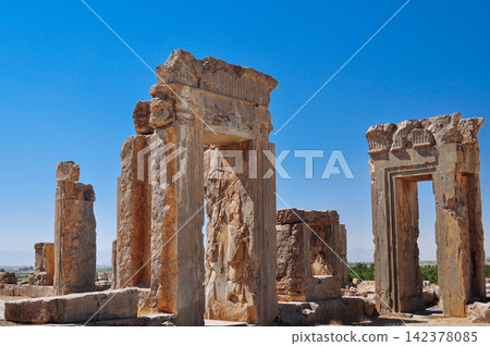 Ancient Persian Ruins and Stone Gateways Under Blue Sky Ancient Persian Ruins and Stone Gateways Under Blue Sky 142378085