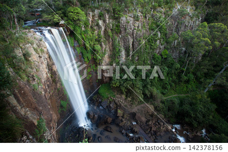 Waterfall in Lush Forest Canyon with Rocky Cliffs Waterfall in Lush Forest Canyon with Rocky Cliffs 142378156