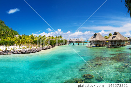 Tropical Island Resort with Overwater Bungalows and Turquoise Lagoon 142378231