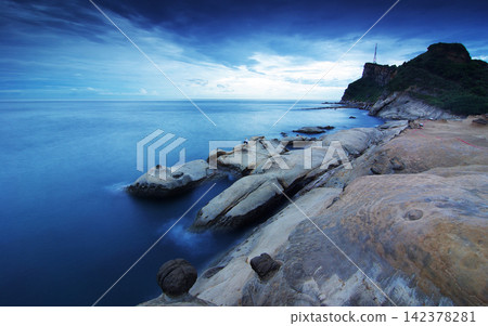 Rocky Coastal Seascape at Blue Hour with Calm Ocean and Cliffs Rocky Coastal Seascape at Blue Hour with Calm Ocean and Cliffs 142378281