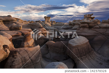 Desert Badlands Hoodoos at Sunset Under Dramatic Sky Desert Badlands Hoodoos at Sunset Under Dramatic Sky 142378328