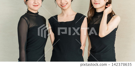 Beauty portraits of three women in black fashion, smiling elegantly. 142378635