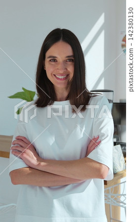Vertical video. Portrait of a cheerful female barista in a cozy coffee shop. Vertical video. Portrait of a cheerful female barista in a cozy coffee shop. 142380130