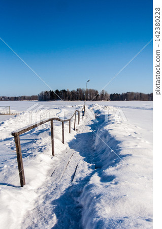 Frost snowflakes on wood, bridge with sun and snow Frost snowflakes on wood, bridge with sun and snow 142380228