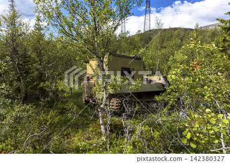 Old Soviet GT-SM GAZ-71 tracked all-terrain vehicle overgrown in forest in Murmansk Oblast, Russia 142380327