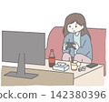 A woman engrossed in a game on the sofa. 142380396