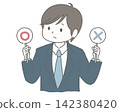 A man in a suit is troubled, holding a checkmark or cross sign. 142380420