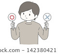 A man ponders, holding a checkmark and a cross. 142380421