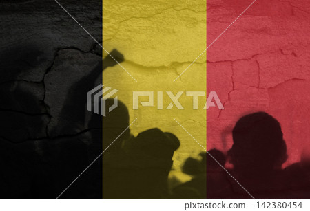 Silhouettes of protesting people casting shadows against a cracked wall with the Belgian flag texture. Civil unrest, strike, demonstration, and social protest concept. Protest Belgium Silhouettes of protesting people casting shadows against a cracked wall with the Belgian flag texture. Civil unrest, strike, demonstration, and social protest concept. Protest Belgium 142380454