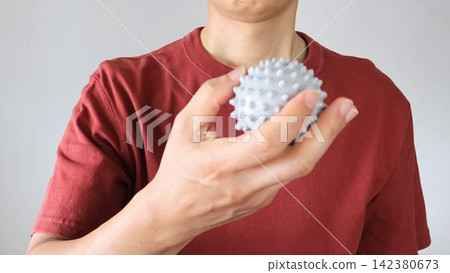 A man using a massage ball A man using a massage ball 142380673
