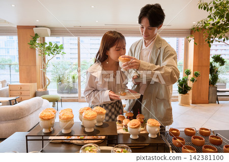 A couple enjoying soup in pastry at a hotel buffet. A couple enjoying soup in pastry at a hotel buffet. 142381100