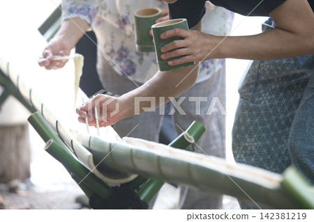 A scene of eating nagashi somen (flowing noodles). A scene of eating nagashi somen (flowing noodles). 142381219