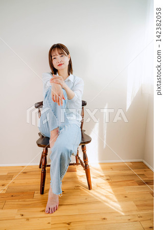 A young woman relaxing indoors A young woman relaxing indoors 142382058