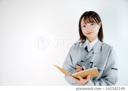 Female staff in work clothes during on-site work Female staff in work clothes during on-site work 142382149
