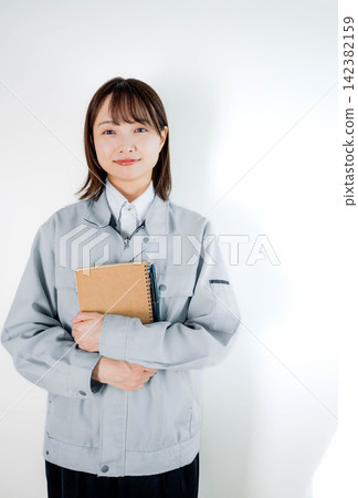 Female staff in work clothes during on-site work Female staff in work clothes during on-site work 142382159